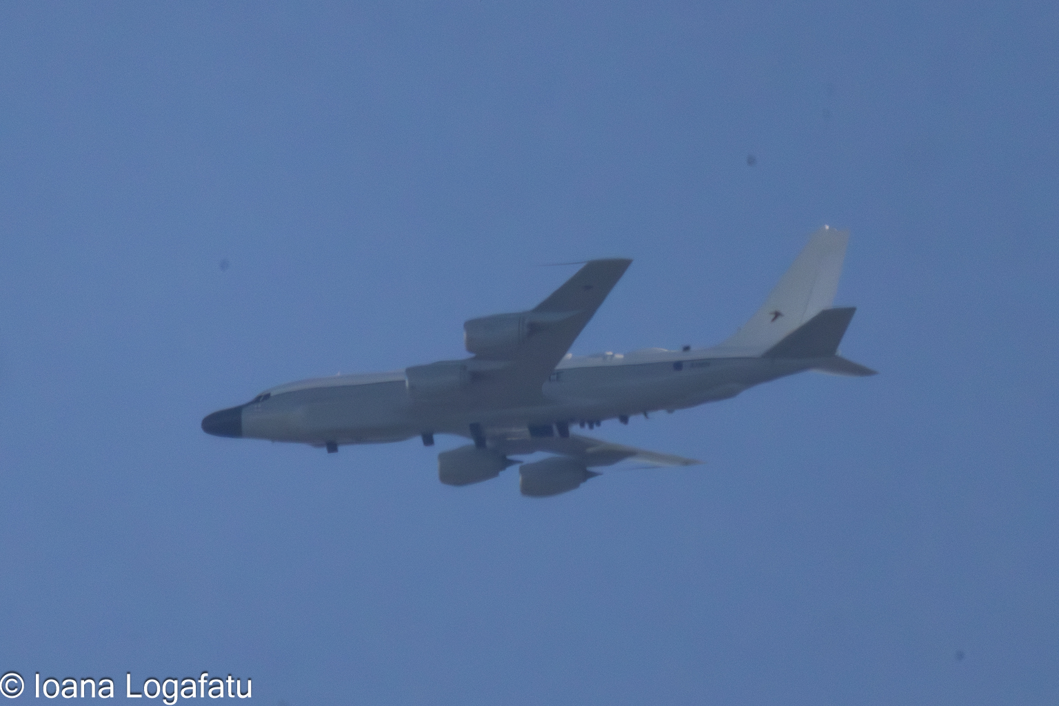 Airplane soaring through the blue sky above